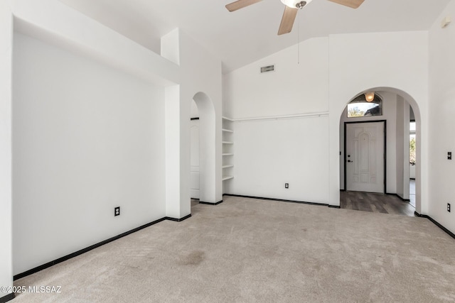 carpeted spare room with high vaulted ceiling and ceiling fan