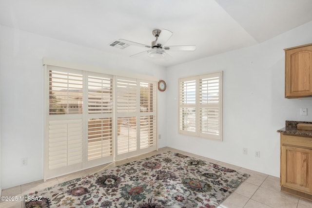 dining area featuring light tile patterned flooring and ceiling fan