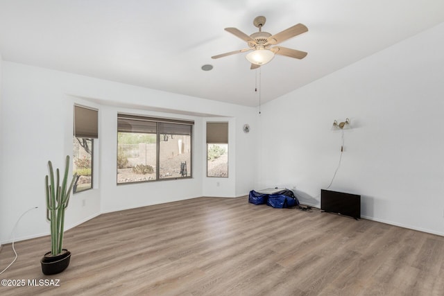 empty room featuring ceiling fan and light hardwood / wood-style flooring