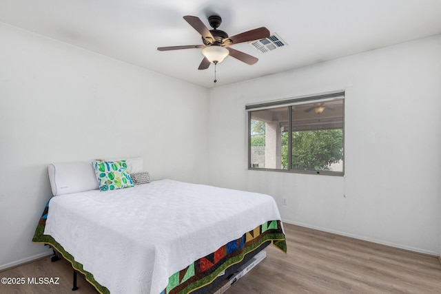 bedroom with hardwood / wood-style flooring and ceiling fan