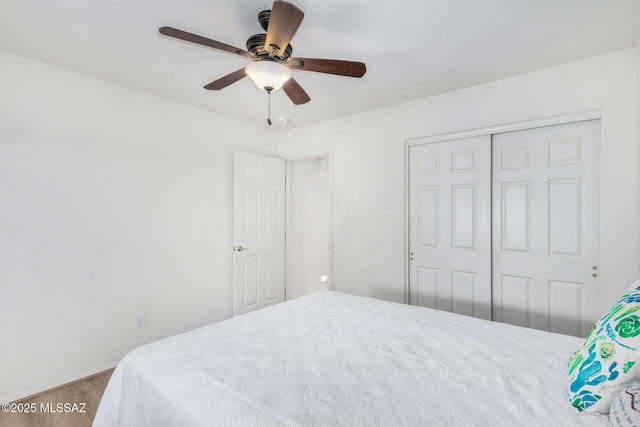 bedroom featuring hardwood / wood-style floors, ceiling fan, and a closet