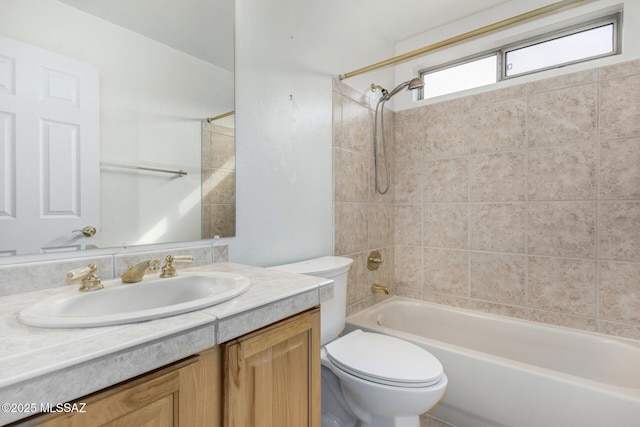 full bathroom featuring vanity, toilet, and tiled shower / bath combo