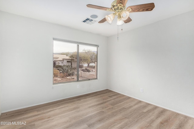 spare room featuring light hardwood / wood-style floors and ceiling fan