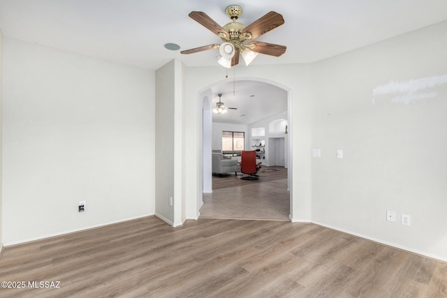 spare room with ceiling fan and light wood-type flooring