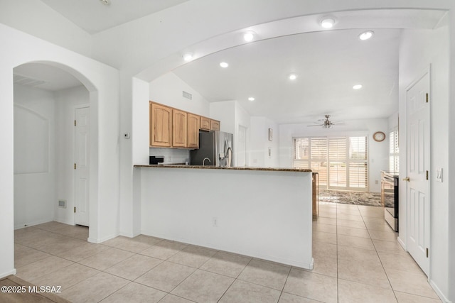 kitchen featuring appliances with stainless steel finishes, light tile patterned floors, ceiling fan, kitchen peninsula, and light stone countertops