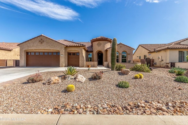 566 N Ramos Ln, Green Valley, AZ 85614 - mediterranean / spanish house featuring driveway, a tile roof, a garage, and stucco siding