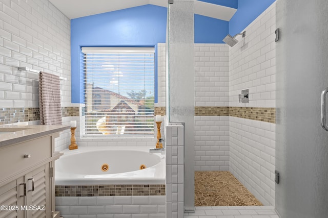 full bathroom with lofted ceiling, a shower stall, a tub with jets, and vanity