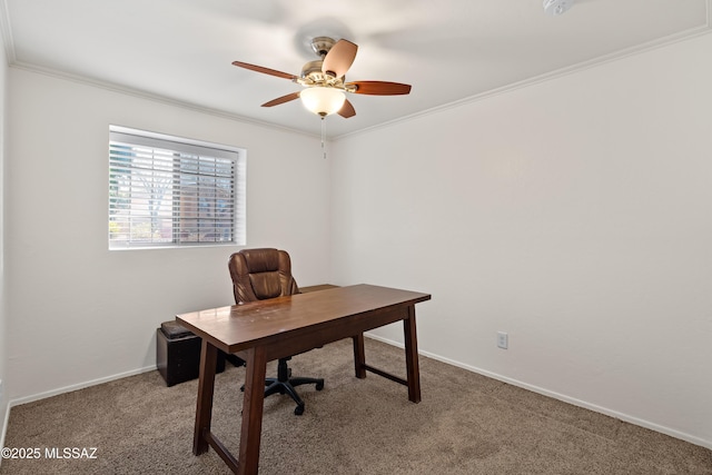 home office with ornamental molding, carpet flooring, a ceiling fan, and baseboards