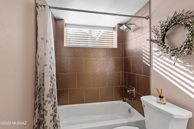 bathroom featuring shower / bath combo and toilet