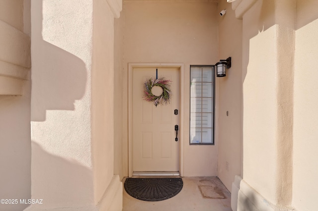 doorway to property with stucco siding