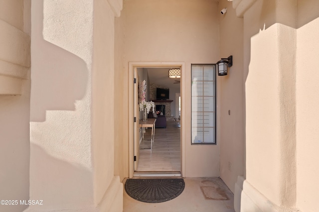 doorway to property featuring stucco siding