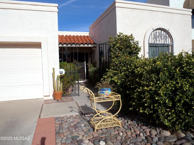 view of patio / terrace with a gate and a garage