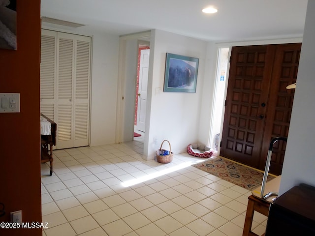 entrance foyer with recessed lighting and light tile patterned floors