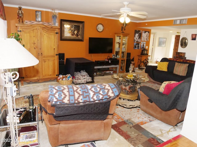 living area with ceiling fan, crown molding, and visible vents