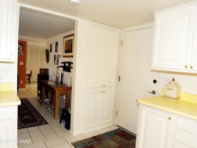 interior space with light countertops, white cabinetry, and light tile patterned floors