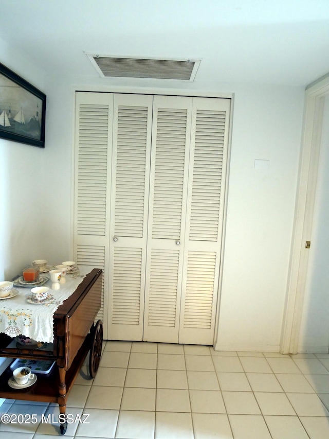 bedroom featuring a closet and light tile patterned floors