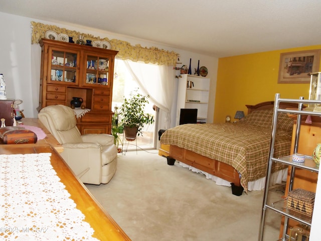 bedroom with carpet flooring and access to exterior