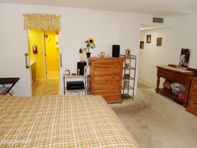 bedroom with visible vents and carpet