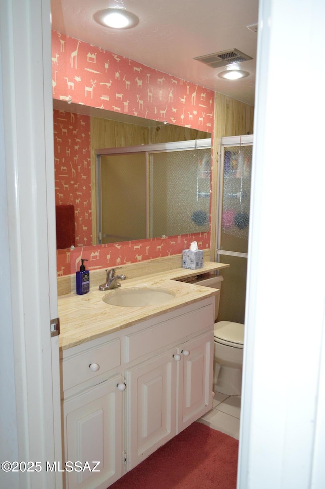 full bath featuring a shower stall, tile patterned floors, visible vents, toilet, and vanity