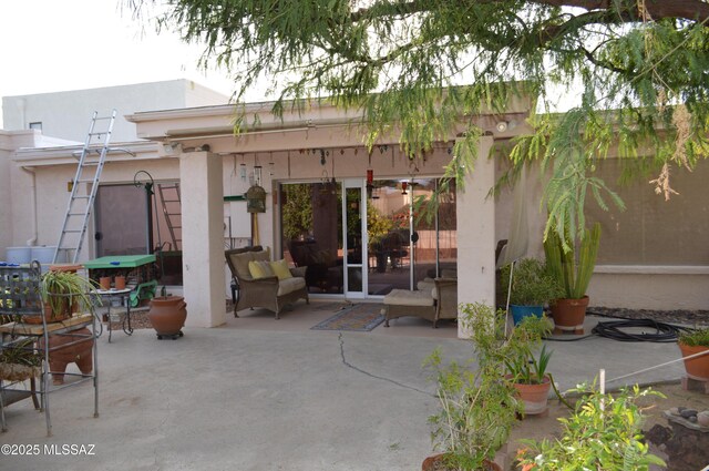 back of house with a patio area and stucco siding