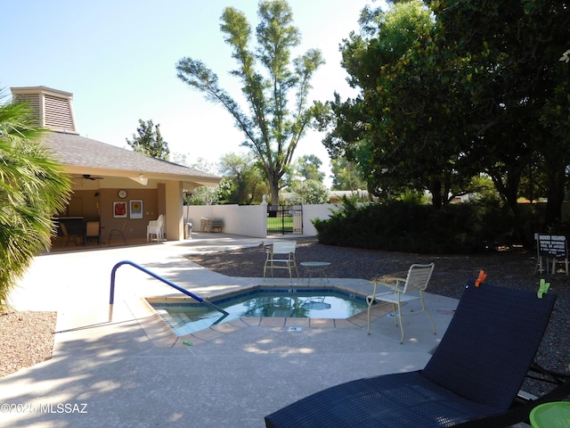 view of swimming pool featuring a community hot tub, ceiling fan, a patio area, and fence