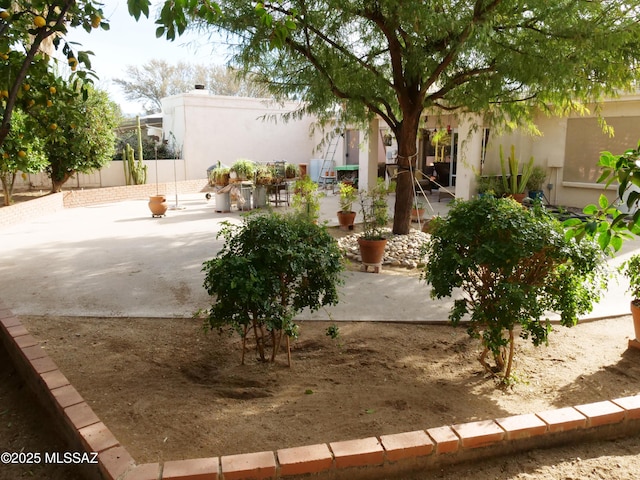 view of yard with fence and a patio