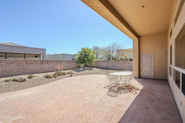 view of patio featuring a fenced backyard and outdoor dining space