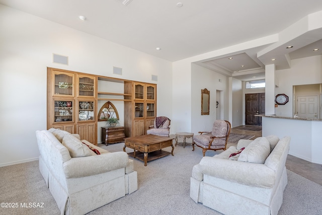 living room with visible vents, a high ceiling, baseboards, and recessed lighting