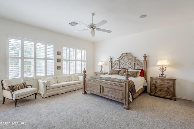 bedroom with light carpet, visible vents, and a ceiling fan