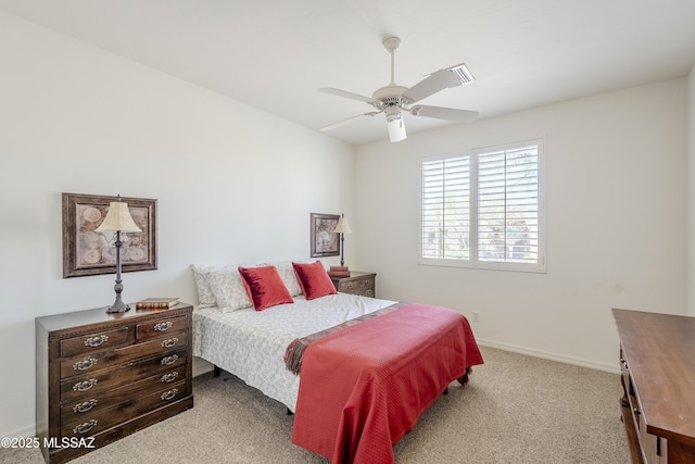 carpeted bedroom with ceiling fan and baseboards