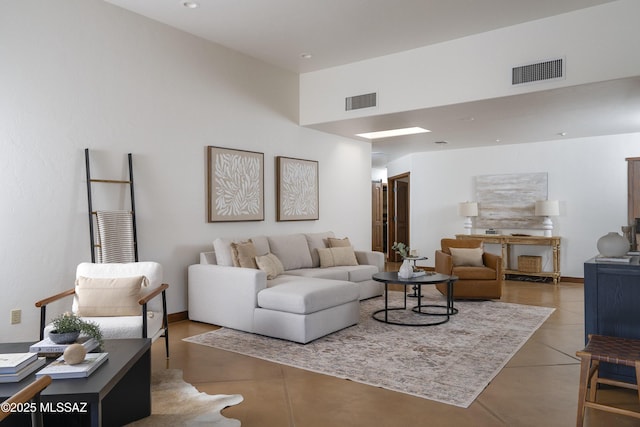 tiled living area with visible vents and recessed lighting