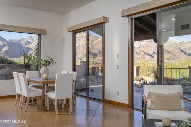 dining area with a mountain view, baseboards, and visible vents