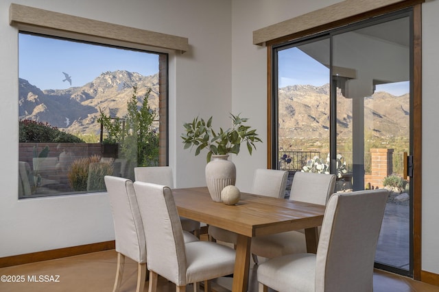 dining area with a mountain view and baseboards