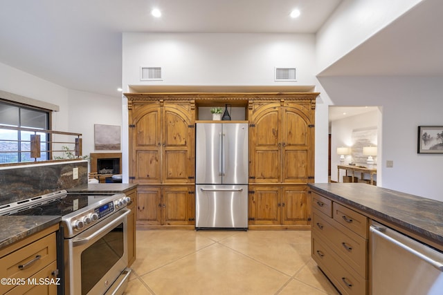 kitchen featuring dark countertops, recessed lighting, visible vents, and stainless steel appliances