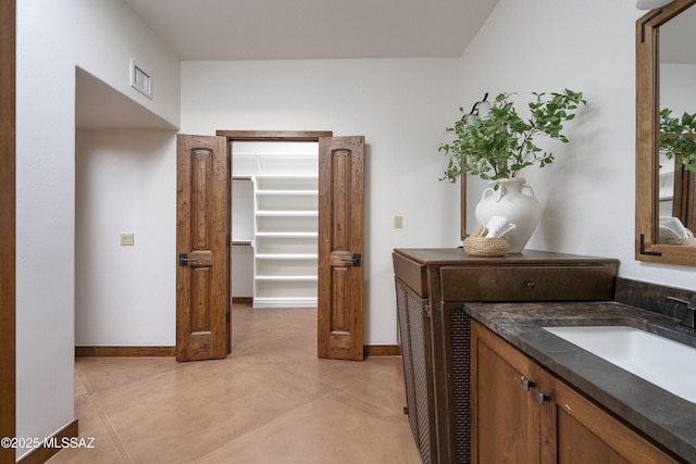 bathroom featuring visible vents, baseboards, concrete floors, and vanity