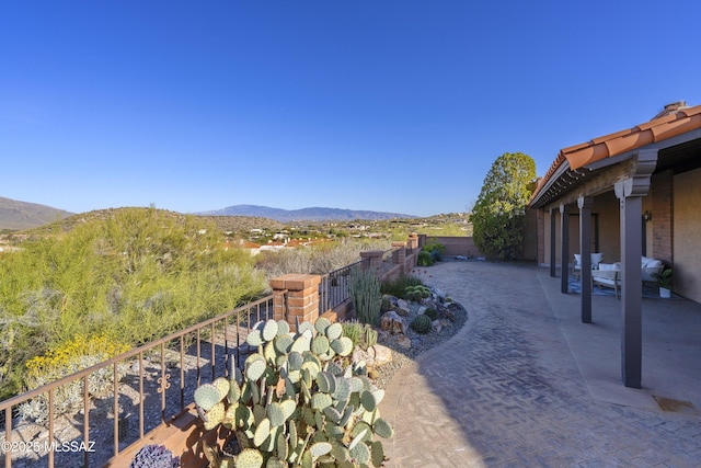 view of yard with a mountain view, a patio, and fence