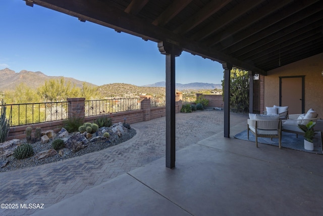 view of patio / terrace with a fenced backyard and a mountain view