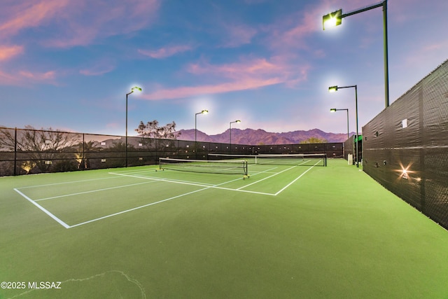 view of sport court featuring community basketball court, fence, and a mountain view