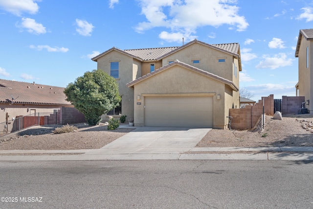 view of front of property featuring a garage, driveway, fence, and stucco siding