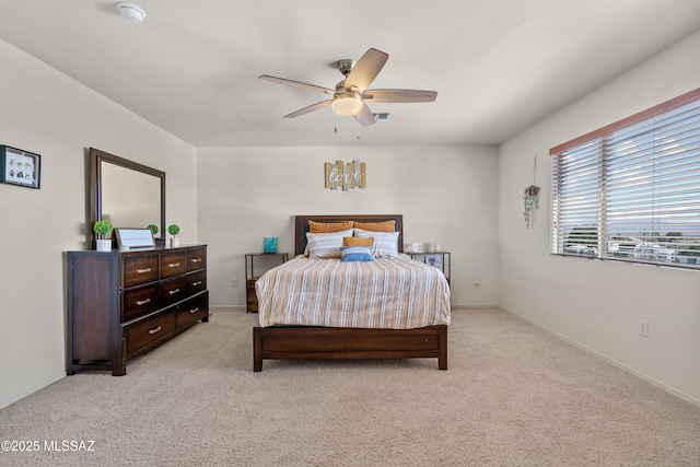 bedroom with ceiling fan, visible vents, and light colored carpet