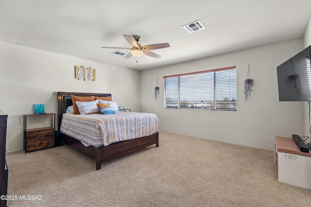 carpeted bedroom featuring ceiling fan and visible vents