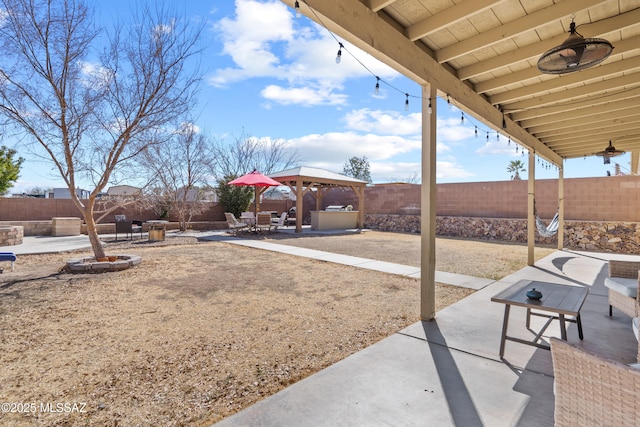 view of yard with a fenced backyard, a patio, and a gazebo