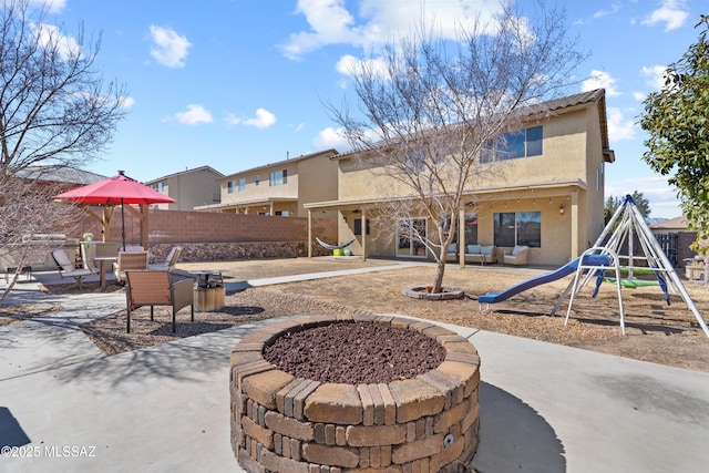 exterior space featuring playground community and fence