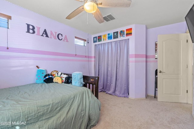 bedroom featuring light colored carpet, visible vents, and ceiling fan