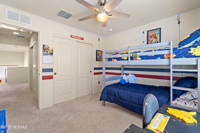 carpeted bedroom featuring a closet, visible vents, and ceiling fan