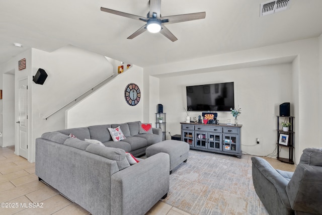 living room featuring ceiling fan and visible vents