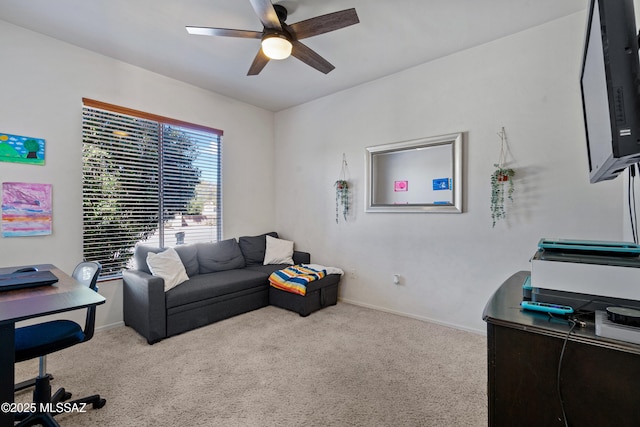 office space featuring carpet floors, baseboards, and a ceiling fan