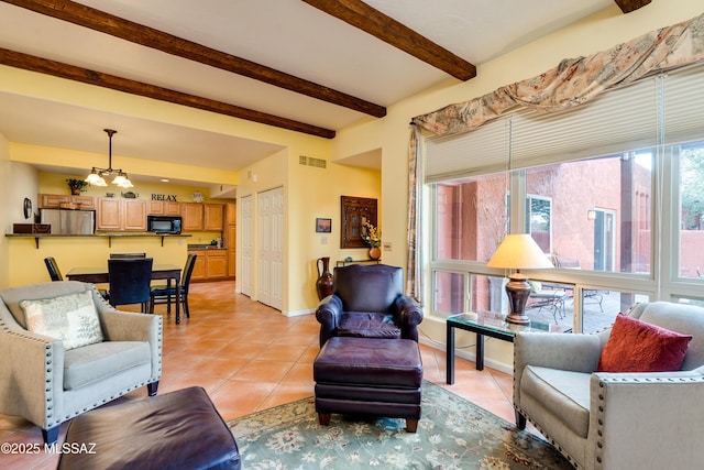 living room with beamed ceiling and light tile patterned floors