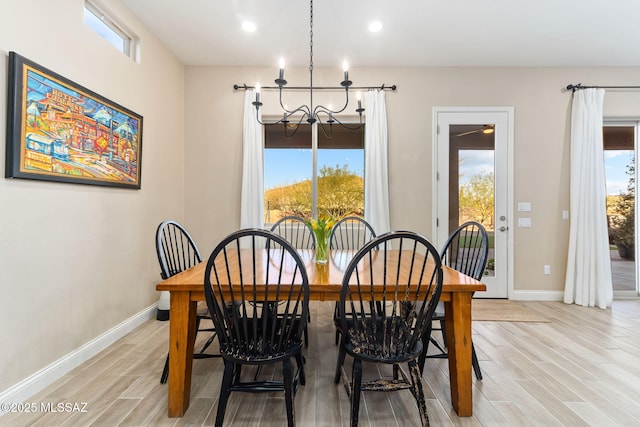 dining area with a notable chandelier and light wood-type flooring