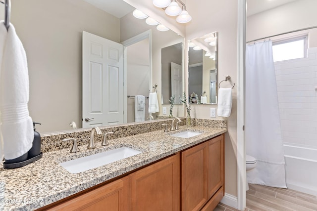 full bathroom featuring vanity, shower / bathtub combination with curtain, and toilet